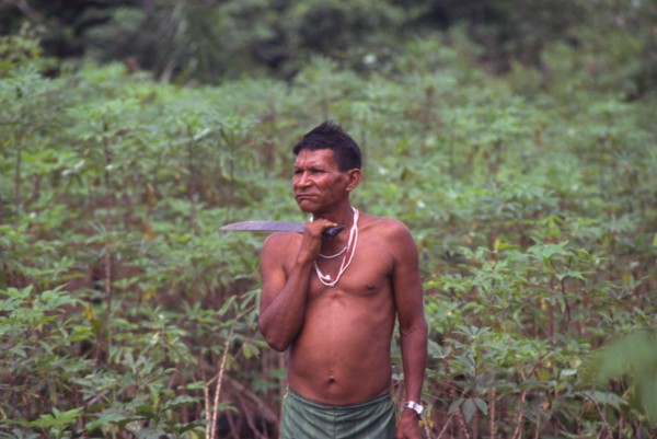 COLOMBIA, Vaupes , "Tukano indian shaman, with machete and chewing coca."