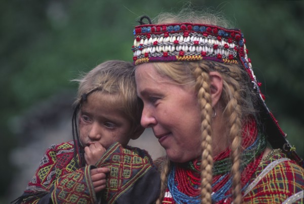 PAKISTAN, North West Frontier Province, Rumbur valley, European anthropologist with Kalash boy.