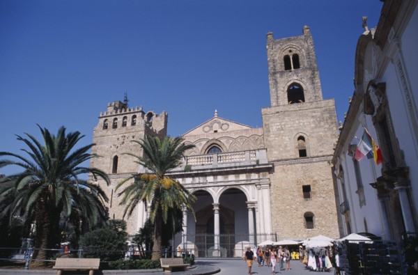 ITALY, Sicily, Palermo, Monreale. II Duomo Norman Cathedral exterior with people walking on road