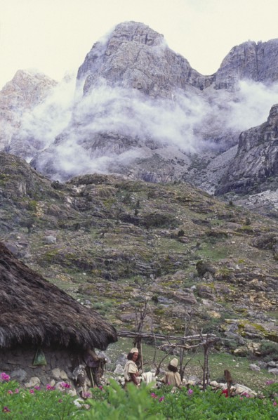 COLOMBIA, Santa Marta, Sierra Nevada , "Two Ica Indian brothers talking, with hut and mountains
