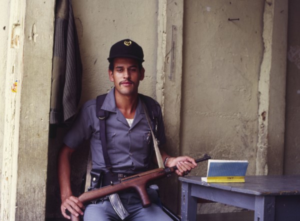 GUATEMALA, Antigua, An armed guard outside the entrance to a prison.