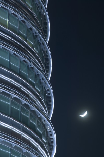 MALAYSIA, Peninsular, Kuala Lumpur, Detail of the Petronis Towers at night with a crescent moon