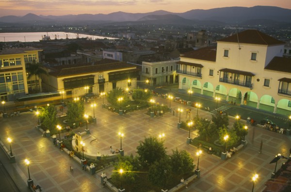 CUBA, Santiago de Cuba, Parque Cespedes at night.  Elevated view over paved square and surrounding