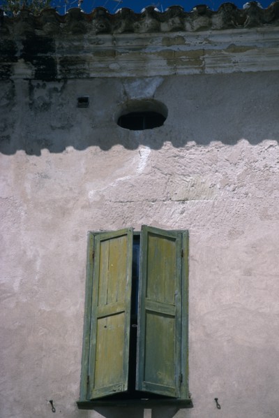 SPAIN, Balearic Islands, Menorca, Mahon.  Detail of house facade with green window shutter in Plaza