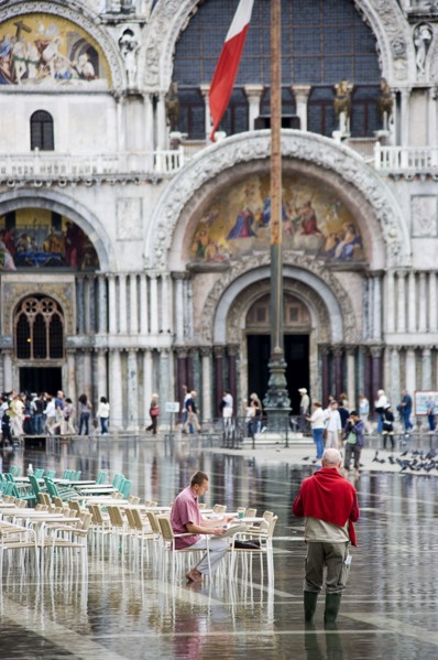 ITALY, Veneto, Venice, Aqua Alta High Water flooding in St Marks Square showing St Marks Basilica