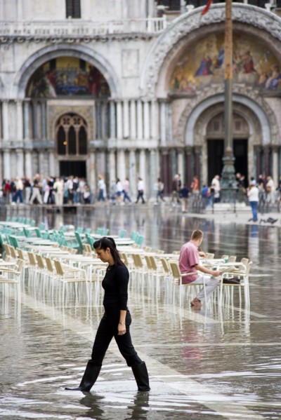 ITALY, Veneto, Venice, Aqua Alta High Water flooding in St Marks Square showing St Marks Basilica