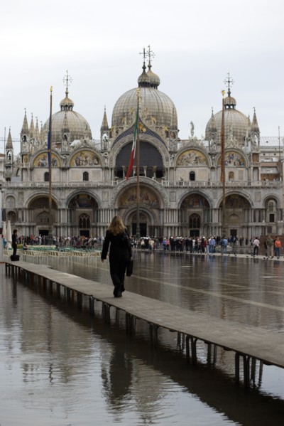 ITALY, Veneto, Venice, Aqua Alta High Water flooding in St Marks Square showing St Marks Basilica