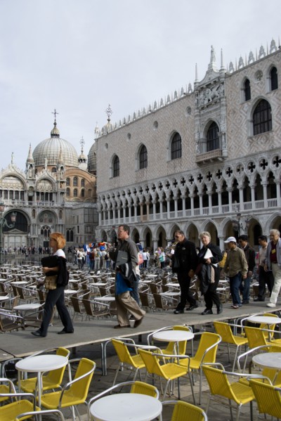 ITALY, Veneto, Venice, Aqua Alta High Water flooding in St Marks Square with tourists walking on an