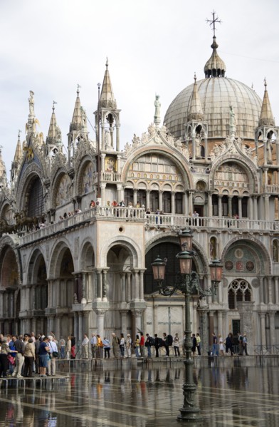 ITALY, Veneto, Venice, Aqua Alta High Water flooding in St Marks Square with tourists walking on