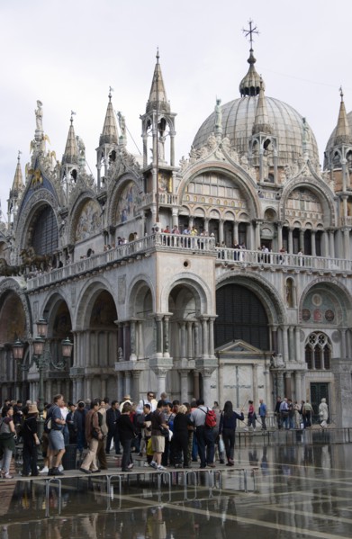 ITALY, Veneto, Venice, Aqua Alta High Water flooding in St Marks Square with tourists walking on