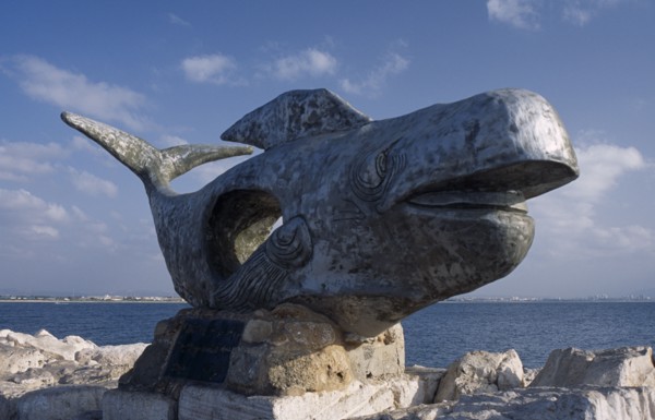 ISRAEL, Acre, A giant sculpture of a whale with the sea in the background