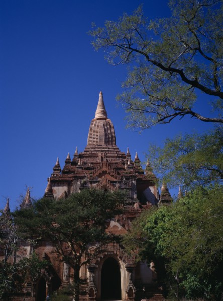 MYANMAR, Bagan, Shwegugyi Pahto or Great Golden Cave in old city.  Exterior framed by trees showing