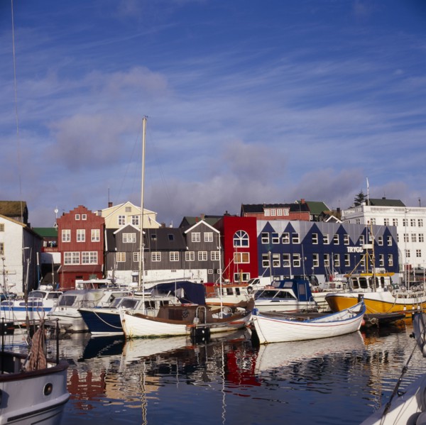 DENMARK, Faroe Islands, Torshavn, Boats moored in harbour with colourful waterfront buildings