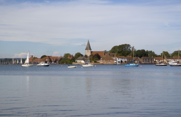 ENGLAND, West Sussex, Bosham, View across water toward Old Bosham with the church spire visible