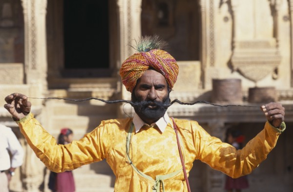 INDIA, Rajasthan, Jaisalmer, Portrait of man displaying the World’s Longest Moustache and wearing
