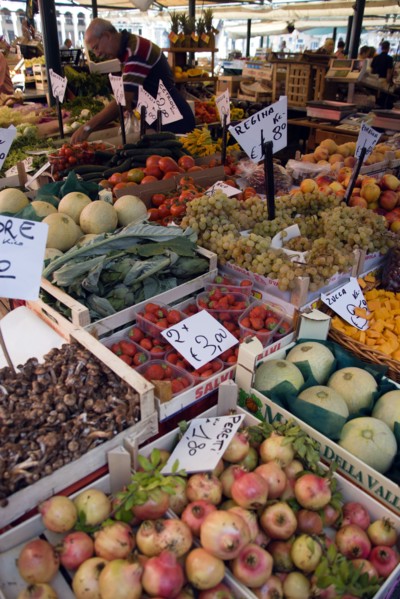 ITALY, Veneto, Venice, Fruit and vegetable stall in the Rialto market with vendor working