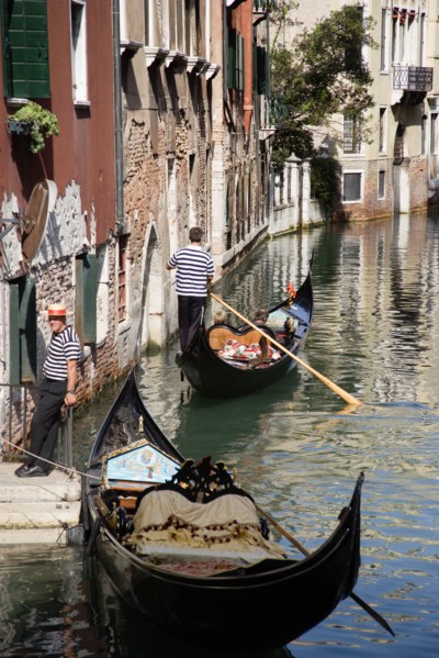 ITALY, Veneto, Venice, A Gondola with tourists passing along a canal in the San Marco district.