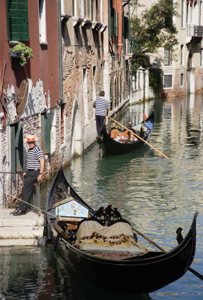 ITALY, Veneto, Venice, A Gondola with tourists passing along a canal in the San Marco district.