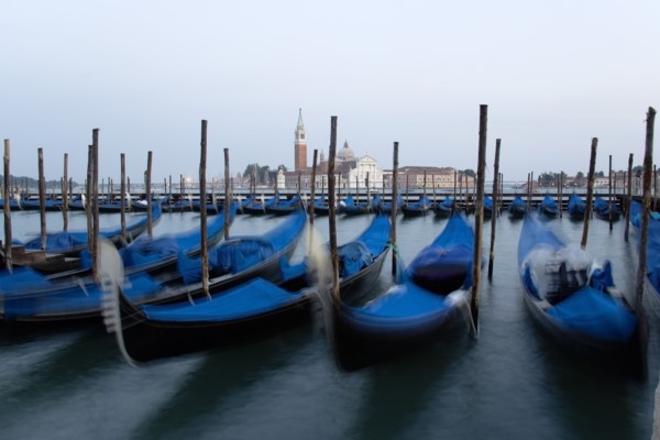 ITALY, Veneto, Venice, Gondolas moored at dusk in the Molo San Marco basin with Palladio's church