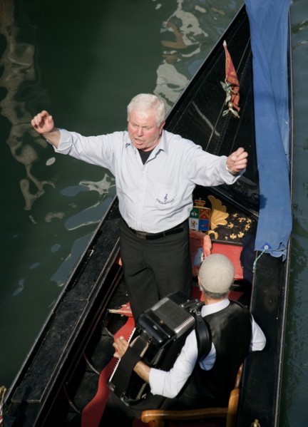 ITALY, Veneto, Venice, A serenader with an accordian player on a gondola