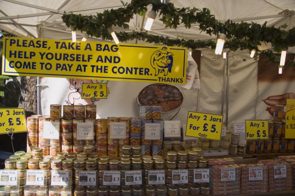 ENGLAND, West Sussex, Shoreham-by-Sea, French Market. Stall with a selection of jars and tinned