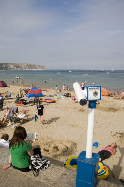 ENGLAND, Dorset, Swanage Bay, View over busy sandy beach with sunbathers on the sand towards the