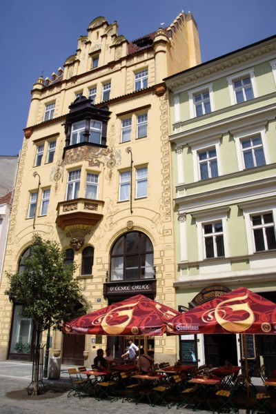 CZECH REPUBLIC, Bohemia, Prague, "Old Town. Tourists sitting at tables under umbrellas outside a