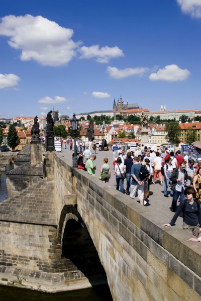 CZECH REPUBLIC, Bohemia, Prague, Tourists on the Charles Bridge across the Vltava River with Prague