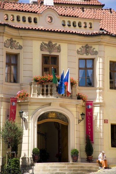 CZECH REPUBLIC, Bohemia, Prague, Woman sitting on the steps up to the Residence Hotel de Charme in
