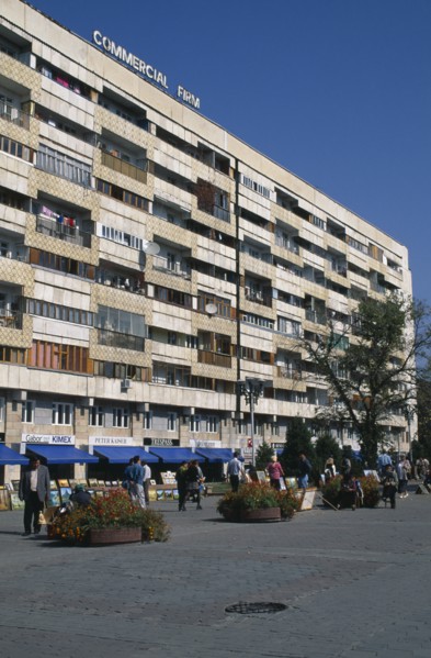 KAZAKHSTAN, Almatr, Street scence with people selling paintings in front of shops and apartrments.
