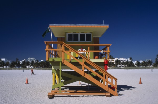 USA, Florida, Miami, South Beach. Ocean Drive. Orange and Green Lifeguard station on sandy beach