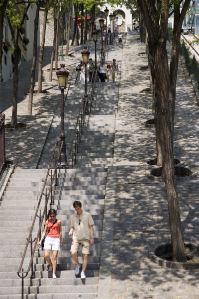 FRANCE, Ile de France, Paris, Montmartre People on the tree lined steps of the Rue Foyatier beside