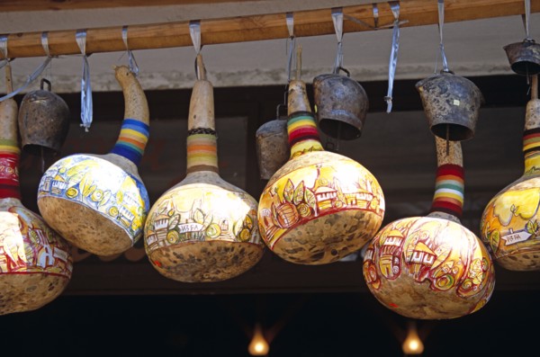 BULGARIA, Melnik., Colourful gourds and cattle bells hanging outside shop.