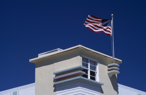USA, Florida, Miami, South Beach. Ocean Drive. Detail of an Art Deco building with an American flag