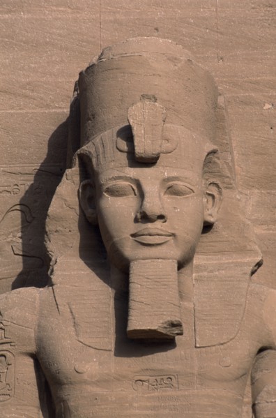 EGYPT, Nile Valley, Abu Simbel, Ramses II colossal enthroned statue. Detail of head and upper torso
