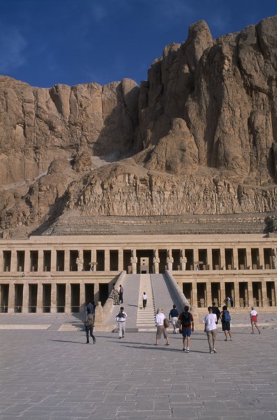 EGYPT, Nile Valley, Thebes, Deir el-Bahri. Hatshepsut Mortuary Temple. Visitors walking towards