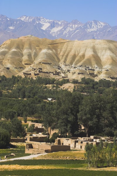 AFGHANISTAN, Bamiyan Province, Bamiyan, View over the village with mountains behind.