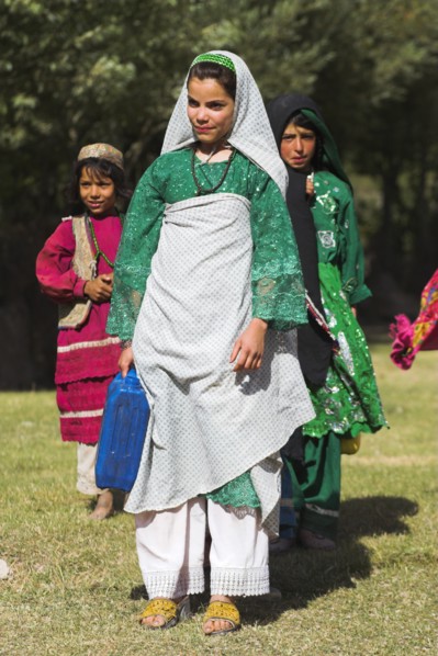 AFGHANISTAN, Ghor Province, Pal-Kotal-i-Guk, "Aimaq nomad camp, Women and girl carry containers