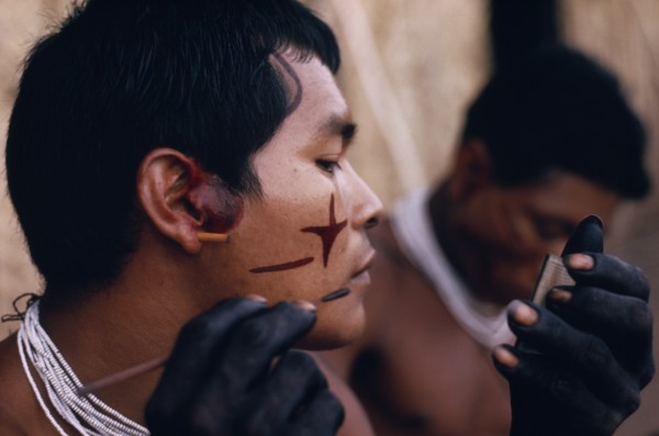 COLOMBIA, North West Amazon, Tukano Indigenous People, Barasana man looking in traded mirror to