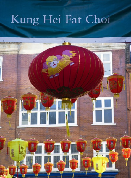 ENGLAND, London, Chinatown, Lion Dance troupe and musicians performing in Wardour Street amongst