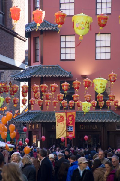 ENGLAND, London, Chinatown, Lion Dance troupe and musicians performing in Wardour Street amongst