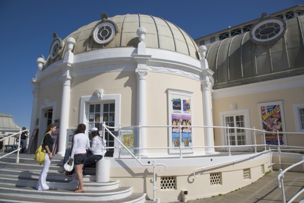 ENGLAND, West Sussex, Worthing, The Pavilion Theatre exterior with a group of girls on the steps