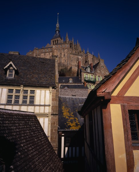 FRANCE, Normandy, Mont-St-Michel, The Abbey on hilltop above houses seen from Liberty Tower.