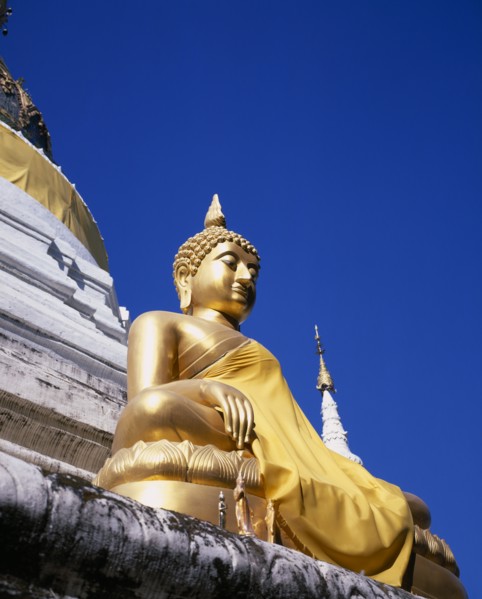 THAILAND, North, Chiang Mai, Seated golden Buddha statue robed in gold silk.