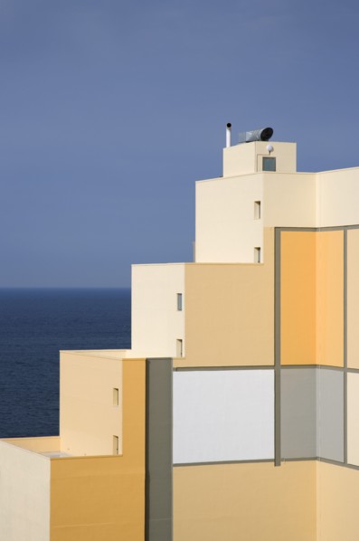 MALTA, Paceville, Stepped structure of seaside building with pattern of square coloured decoration