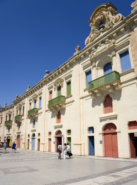 MALTA, Valletta, People walking by the waterfront redevelopment of old Baroque Pinto wharehouses