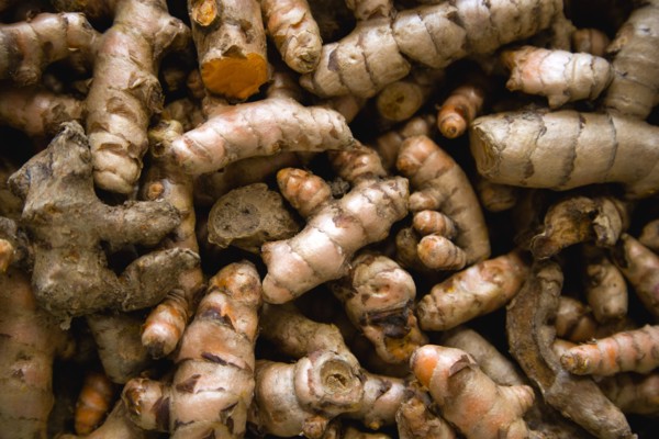 WEST INDIES, St Lucia, Castries, Market spice stall with galangal a member of the ginger family