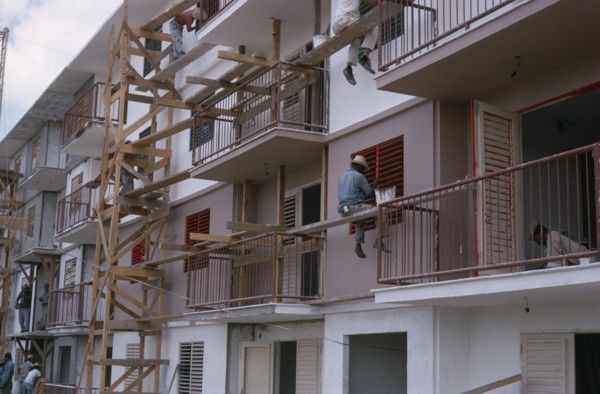 CUBA, Industry, Construction workers and painters on wooden scaffolding working on muli-storey
