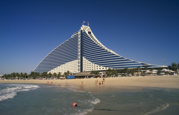 UAE, Dubai , Jumeirah Beach Hotel with people on private beach in foreground.
