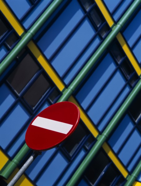 HOLLAND, Noord Holland, Amsterdam, Detail of No Entry road sign with modern colourful apartments